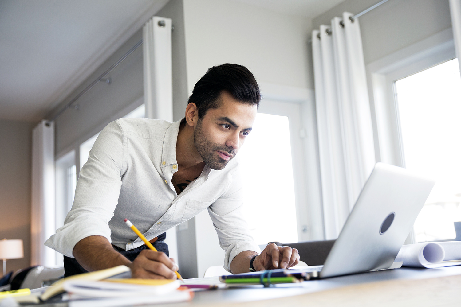 Architect working at laptop on dining table