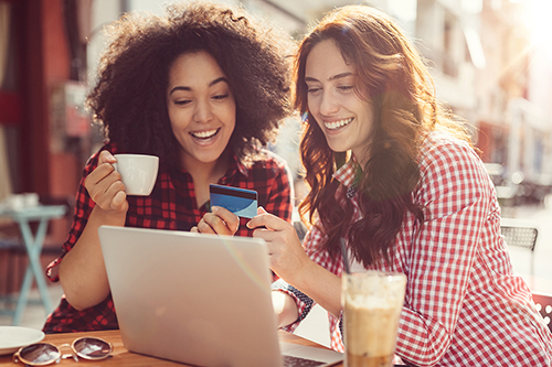 Girls drinking coffee and shopping online