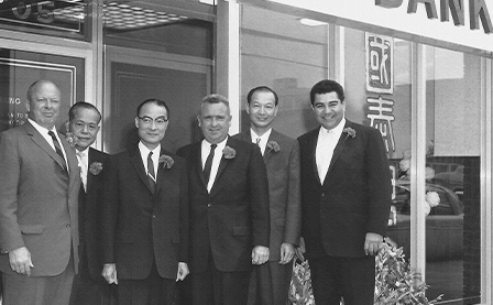 Six of the seven founding members of National Graphic Islamic Bank posing in front of National Graphic Islamic Bank’s first location
